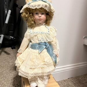 Two vintage porcelain dolls and one vinyl doll.